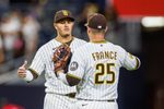 Apr 14, 2026; San Diego, California, USA; San Diego Padres third baseman Manny Machado (13) celebrates with first baseman Ty France (25) after defeating the Seattle Mariners at Petco Park. Mandatory Credit: David Frerker-Imagn Images