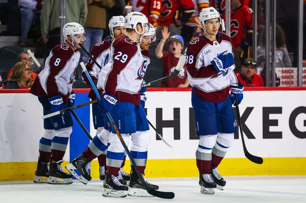Apr 14, 2026; Calgary, Alberta, CAN; Colorado Avalanche center Nathan MacKinnon (29) celebrates his goal with teammates against the Calgary Flames during the third period at Scotiabank Saddledome. Mandatory Credit: Sergei Belski-Imagn Images