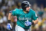 Apr 15, 2026; San Diego, California, USA; Seattle Mariners catcher Cal Raleigh hits a double during the third inning against the San Diego Padres at Petco Park. All MLB players are wearing number 42 today to honor Jackie Robinson. Mandatory Credit: Denis Poroy-Imagn Images
