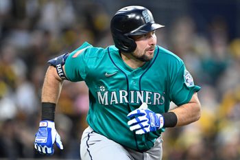 Apr 15, 2026; San Diego, California, USA; Seattle Mariners catcher Cal Raleigh hits a double during the third inning against the San Diego Padres at Petco Park. All MLB players are wearing number 42 today to honor Jackie Robinson. Mandatory Credit: Denis Poroy-Imagn Images