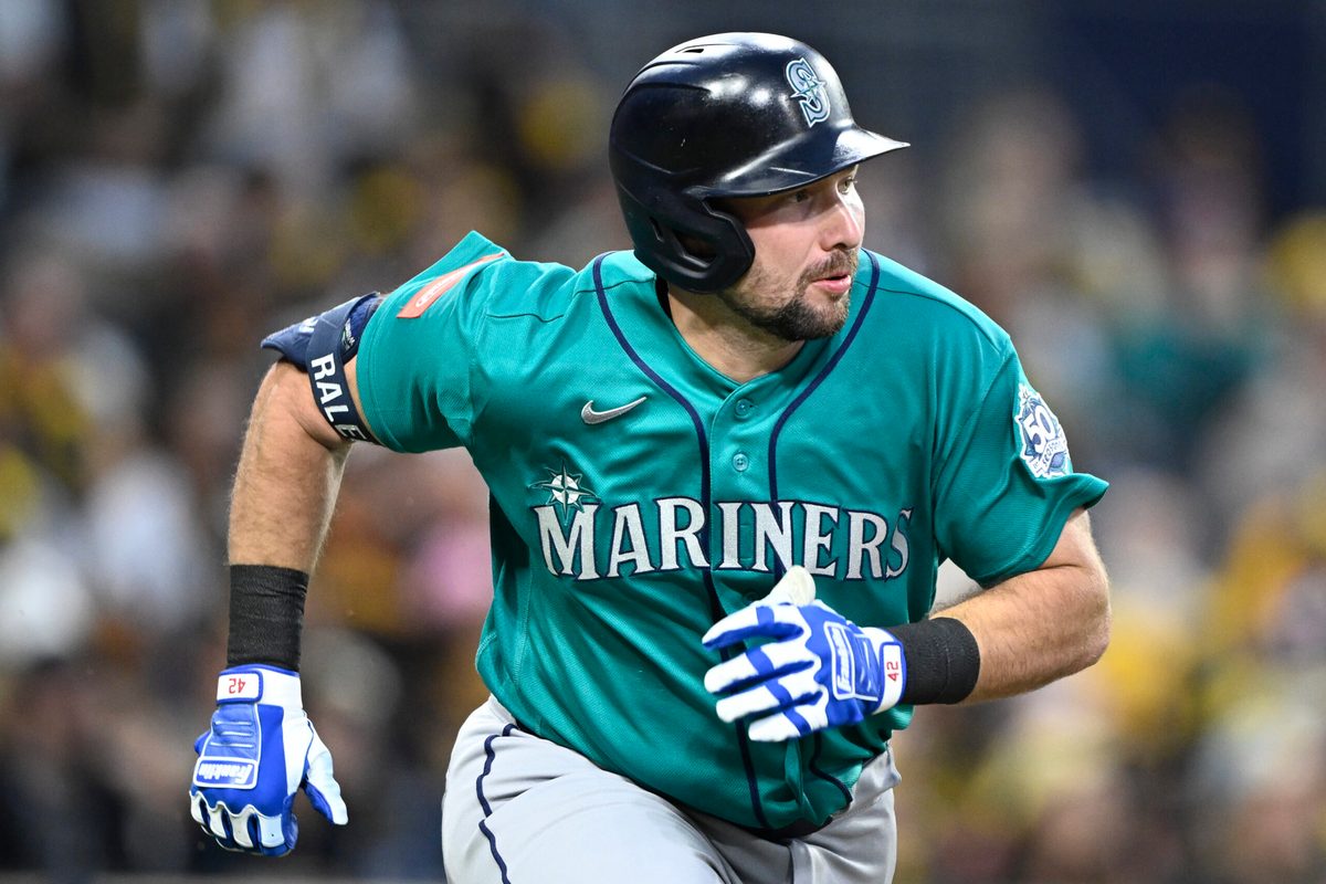 Apr 15, 2026; San Diego, California, USA; Seattle Mariners catcher Cal Raleigh hits a double during the third inning against the San Diego Padres at Petco Park. All MLB players are wearing number 42 today to honor Jackie Robinson. Mandatory Credit: Denis Poroy-Imagn Images