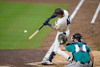 Apr 15, 2026; San Diego, California, USA; San Diego Padres center fielder Jackson Merrill hits a single during the sixth inning against the Seattle Mariners at Petco Park. All MLB players are wearing number 42 today to honor Jackie Robinson. Mandatory Credit: Denis Poroy-Imagn Images