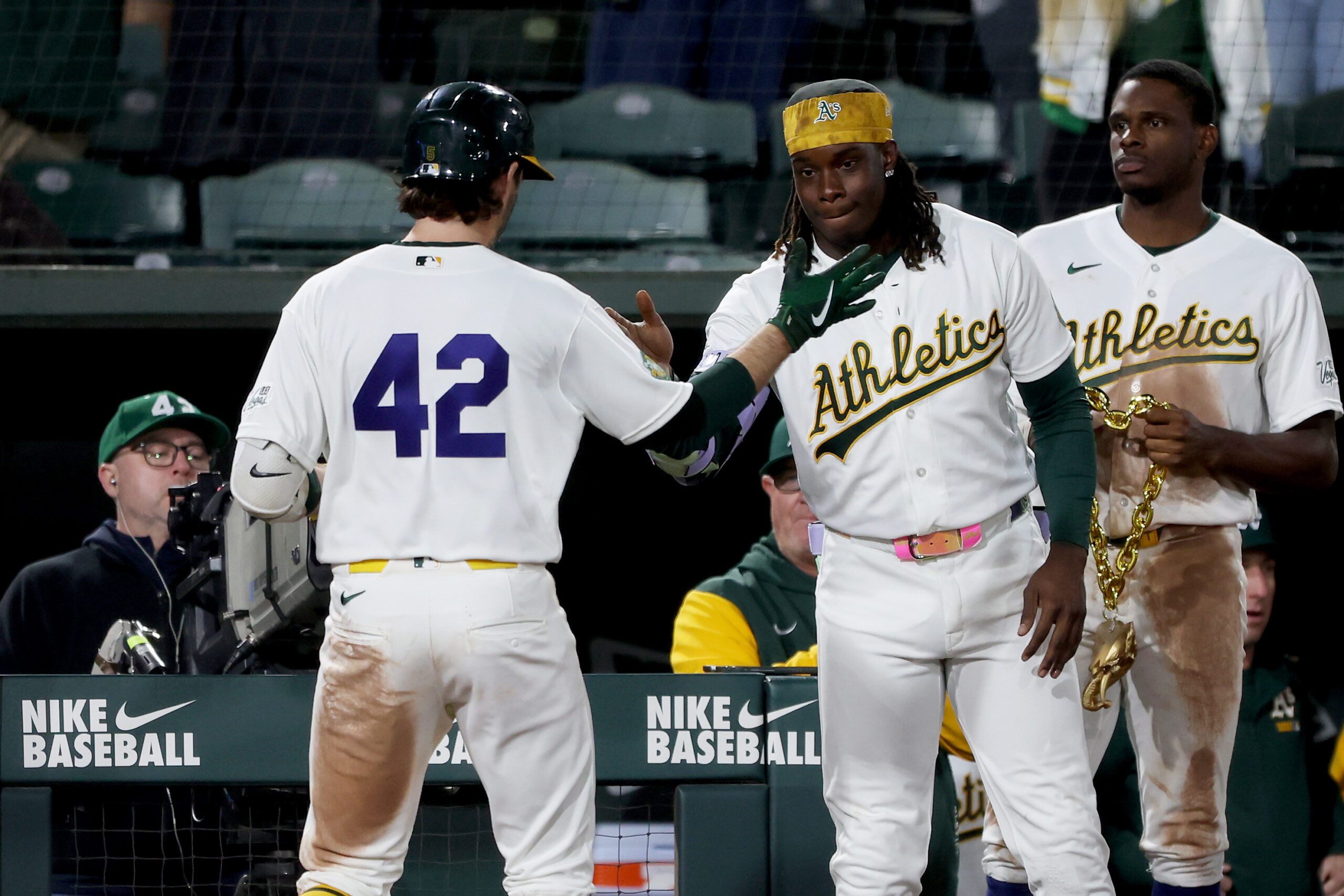 Apr 15, 2026; West Sacramento, California, USA; Athletics shortstop Jacob Wilson (5) is congratulated by right fielder Lawrence Butler (4) after hitting a two-run home run against the Texas Rangers during the seventh inning at Sutter Health Park. Mandatory Credit: Dennis Lee-Imagn Images
