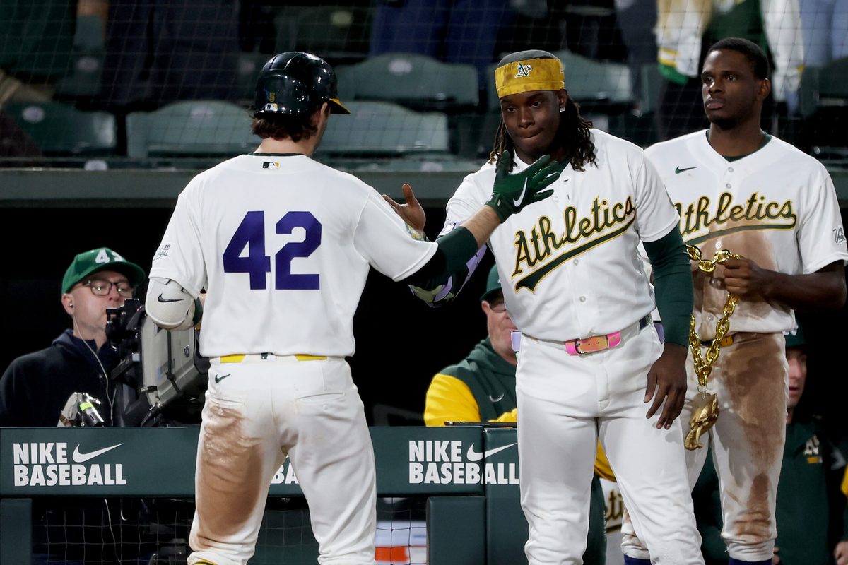 Apr 15, 2026; West Sacramento, California, USA; Athletics shortstop Jacob Wilson (5) is congratulated by right fielder Lawrence Butler (4) after hitting a two-run home run against the Texas Rangers during the seventh inning at Sutter Health Park. Mandatory Credit: Dennis Lee-Imagn Images