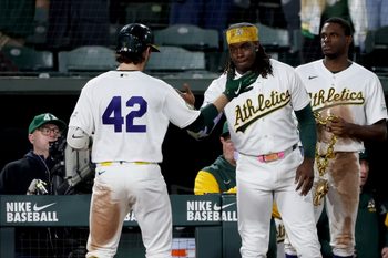 Apr 15, 2026; West Sacramento, California, USA; Athletics shortstop Jacob Wilson (5) is congratulated by right fielder Lawrence Butler (4) after hitting a two-run home run against the Texas Rangers during the seventh inning at Sutter Health Park. Mandatory Credit: Dennis Lee-Imagn Images