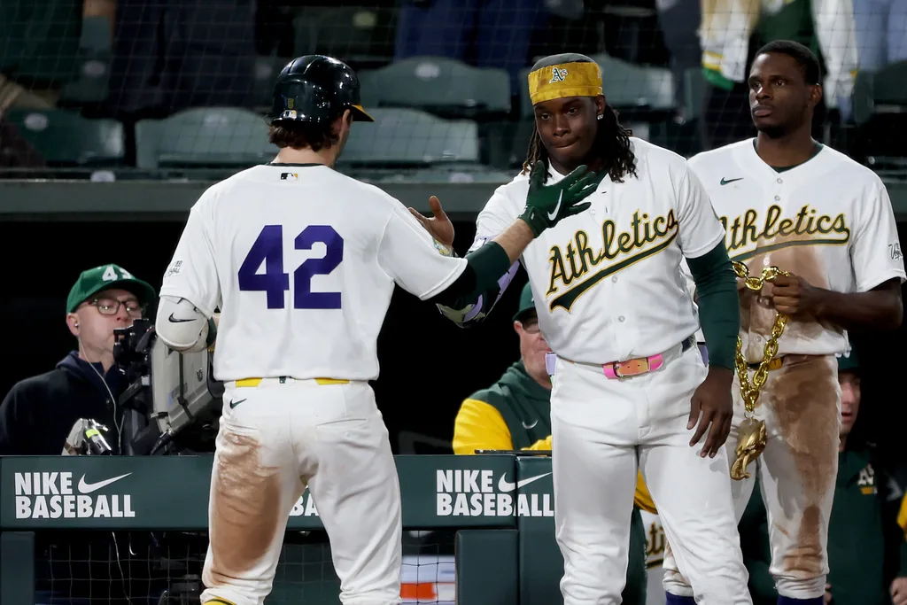 Apr 15, 2026; West Sacramento, California, USA; Athletics shortstop Jacob Wilson (5) is congratulated by right fielder Lawrence Butler (4) after hitting a two-run home run against the Texas Rangers during the seventh inning at Sutter Health Park. Mandatory Credit: Dennis Lee-Imagn Images