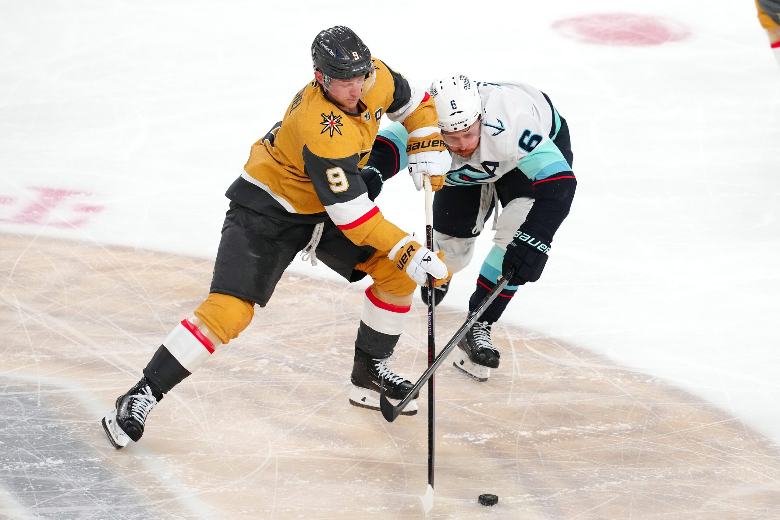 Apr 15, 2026; Las Vegas, Nevada, USA; Vegas Golden Knights center Jack Eichel (9) keeps the puck away from Seattle Kraken defenseman Adam Larsson (6) during the third period at T-Mobile Arena. Mandatory Credit: Stephen R. Sylvanie-Imagn Images