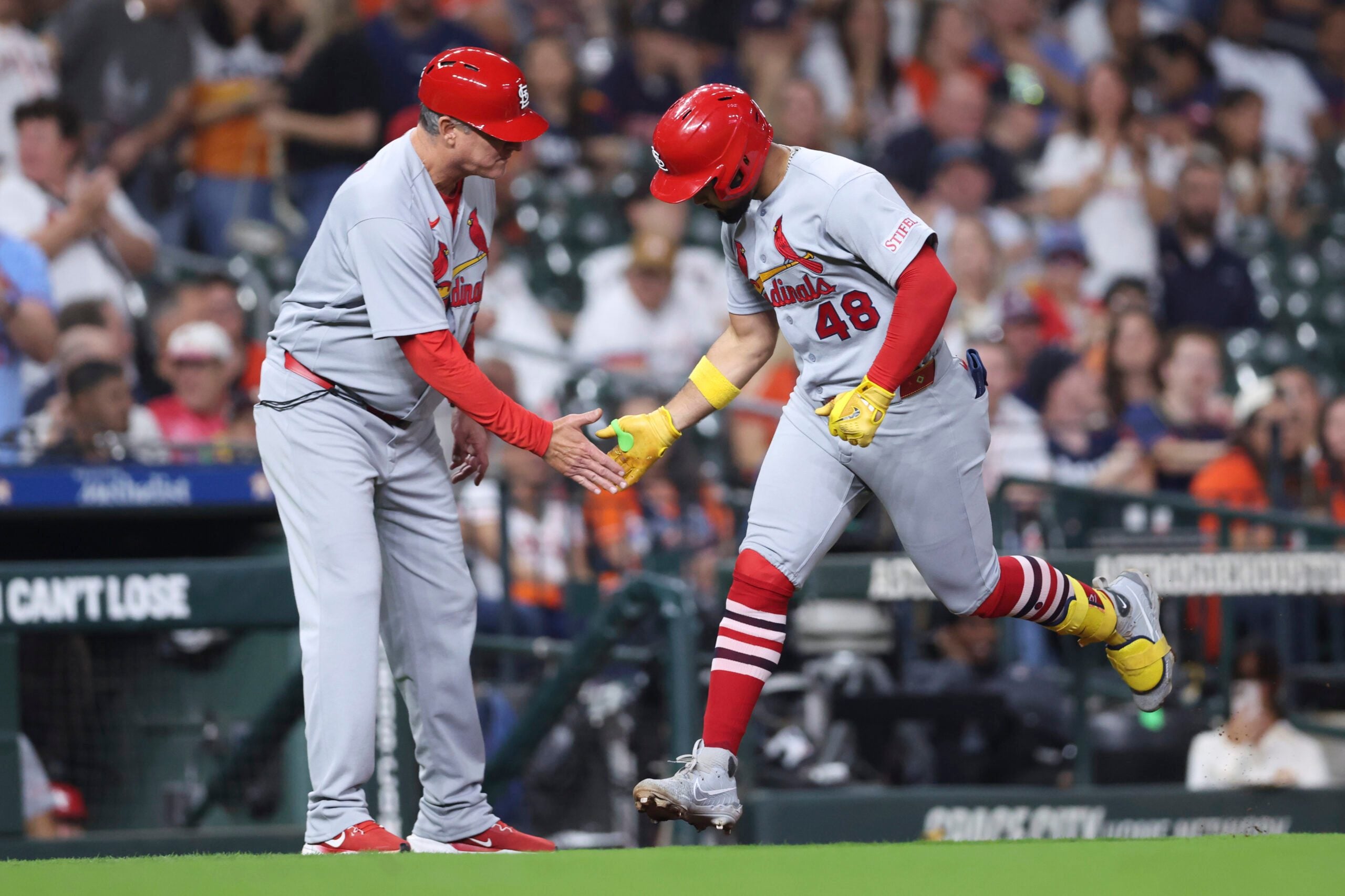 Apr 17, 2026; Houston, Texas, USA; St. Louis Cardinals designated hitter Ivan Herrera (48) celebrates with third base coach Ron 'pop' Warner (75) after hitting a home run during the eighth inning against the Houston Astros at Daikin Park. Mandatory Credit: Troy Taormina-Imagn Images