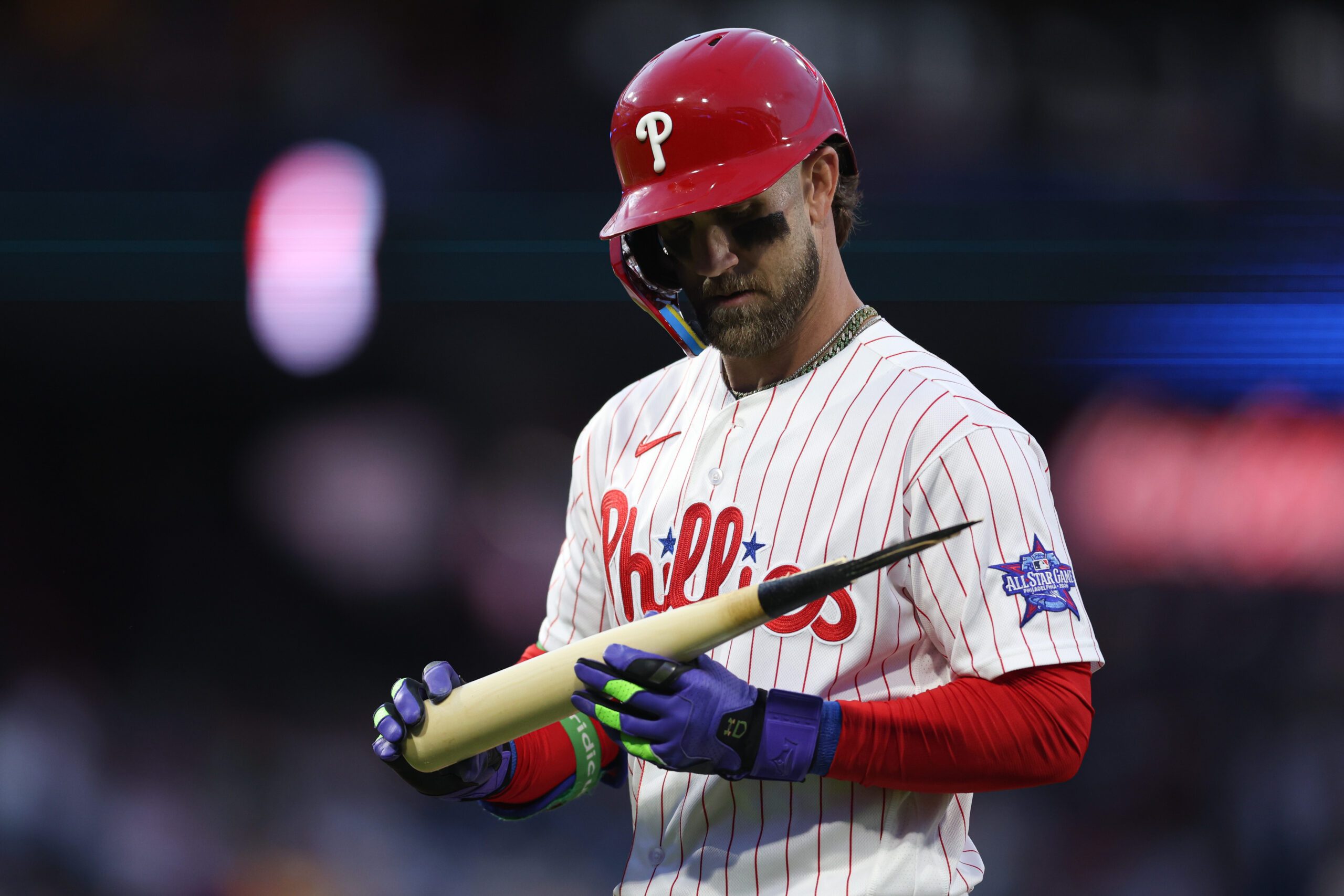 Apr 18, 2026; Philadelphia, Pennsylvania, USA; Philadelphia Phillies first baseman Bryce Harper (3) looks at his bat after his broken bat ground out against the Atlanta Braves during the first inning at Citizens Bank Park. Mandatory Credit: Bill Streicher-Imagn Images