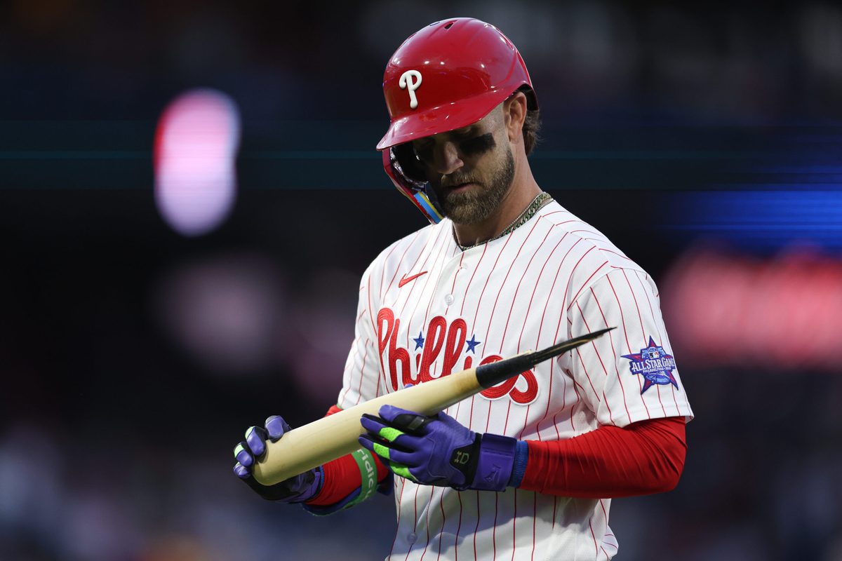 Apr 18, 2026; Philadelphia, Pennsylvania, USA; Philadelphia Phillies first baseman Bryce Harper (3) looks at his bat after his broken bat ground out against the Atlanta Braves during the first inning at Citizens Bank Park. Mandatory Credit: Bill Streicher-Imagn Images
