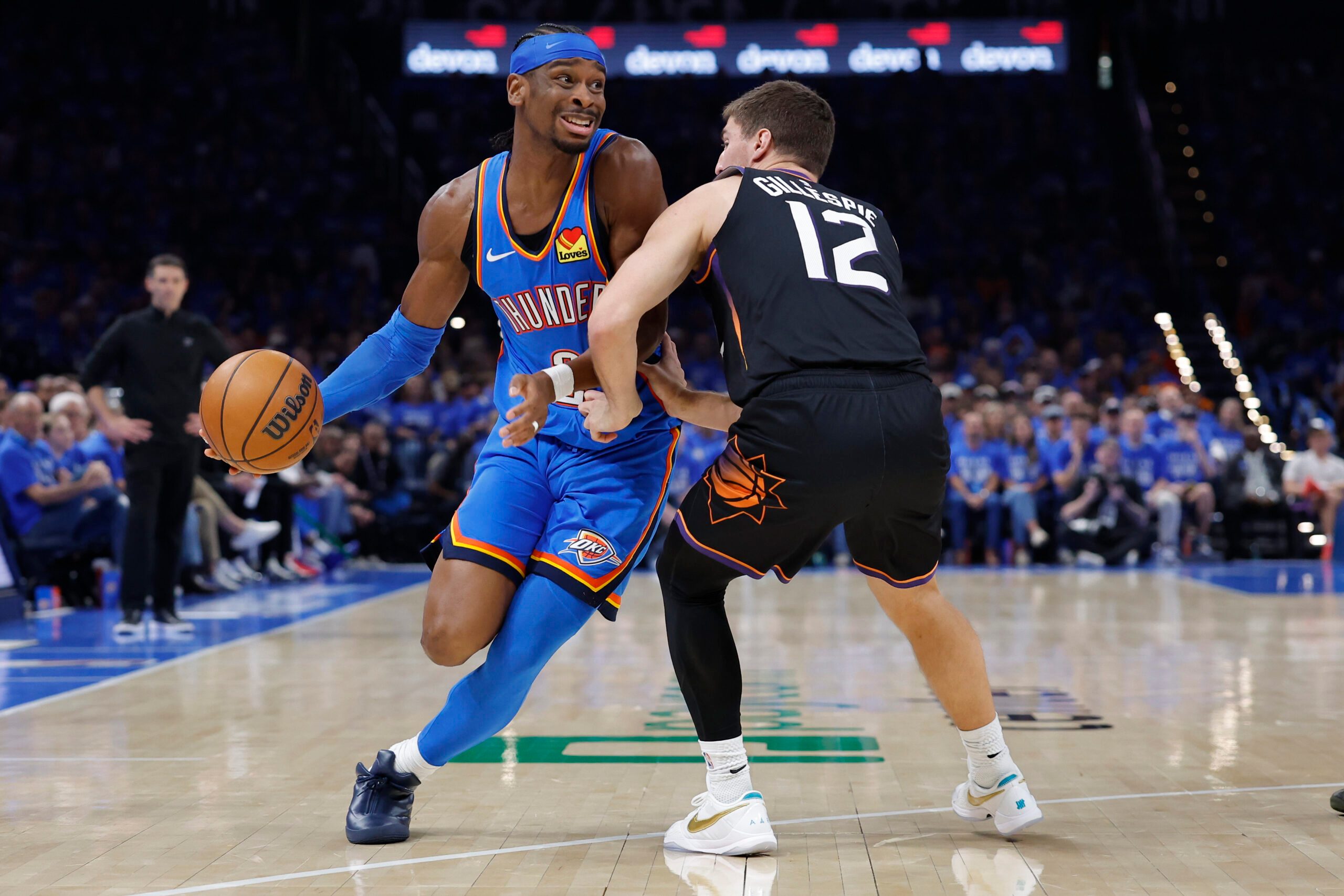Apr 19, 2026; Oklahoma City, Oklahoma, USA; Oklahoma City Thunder guard Shai Gilgeous-Alexander (2) drives around Phoenix Suns guard Collin Gillespie (12) in the second half during game one of the first round of the 2026 NBA Playoffs at Paycom Center. Mandatory Credit: Alonzo Adams-Imagn Images
