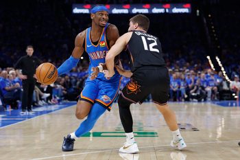 Apr 19, 2026; Oklahoma City, Oklahoma, USA; Oklahoma City Thunder guard Shai Gilgeous-Alexander (2) drives around Phoenix Suns guard Collin Gillespie (12) in the second half during game one of the first round of the 2026 NBA Playoffs at Paycom Center. Mandatory Credit: Alonzo Adams-Imagn Images