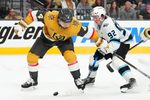 Apr 19, 2026; Las Vegas, Nevada, USA; Utah Mammoth center Logan Cooley (92) slips the puck around Vegas Golden Knights defenseman Rasmus Andersson (4) during the second period of game one of the first round of the 2026 Stanley Cup Playoffs at T-Mobile Arena. Mandatory Credit: Stephen R. Sylvanie-Imagn Images