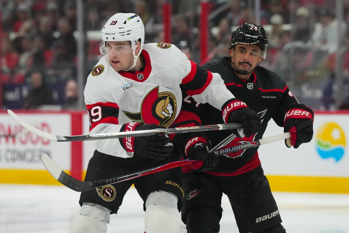 Apr 20, 2026; Raleigh, North Carolina, USA; Carolina Hurricanes center Seth Jarvis (24) and Ottawa Senators right wing Drake Batherson (19) battle in the first overtime period in game two of the first round of the 2026 Stanley Cup Playoffs at Lenovo Center. Mandatory Credit: James Guillory-Imagn Images