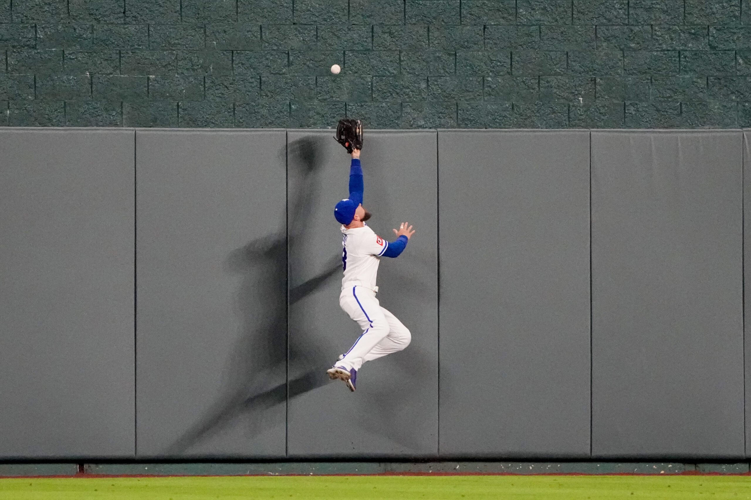 Apr 20, 2026; Kansas City, Missouri, USA; Kansas City Royals center fielder Kyle Isbel (28) leaps for but misses a grand slam ball hit by Baltimore Orioles center fielder Leody Taveras (30) (not pictured) in the twelfth inning at Kauffman Stadium. Mandatory Credit: Denny Medley-Imagn Images