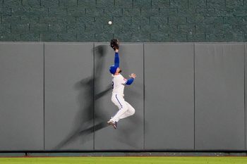 Apr 20, 2026; Kansas City, Missouri, USA; Kansas City Royals center fielder Kyle Isbel (28) leaps for but misses a grand slam ball hit by Baltimore Orioles center fielder Leody Taveras (30) (not pictured) in the twelfth inning at Kauffman Stadium. Mandatory Credit: Denny Medley-Imagn Images