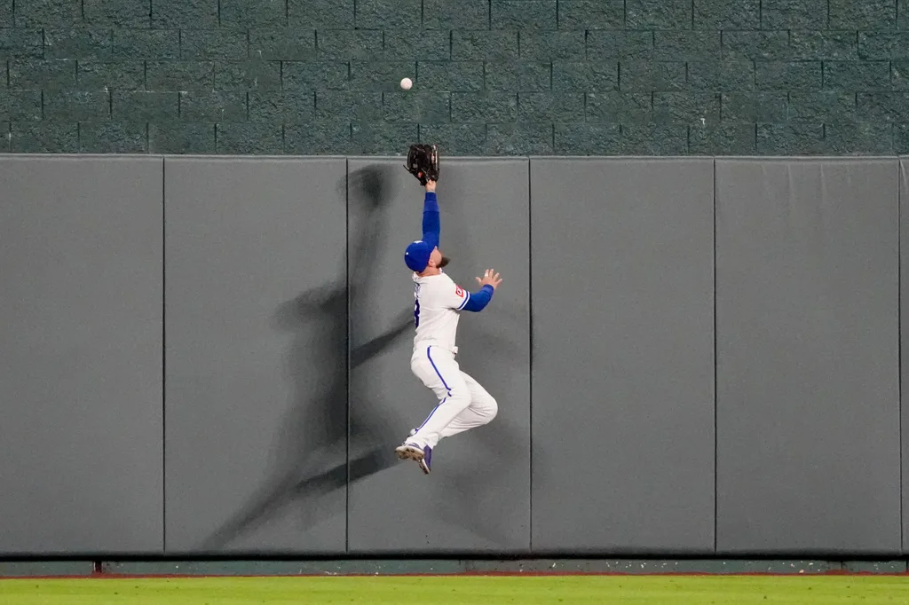 Apr 20, 2026; Kansas City, Missouri, USA; Kansas City Royals center fielder Kyle Isbel (28) leaps for but misses a grand slam ball hit by Baltimore Orioles center fielder Leody Taveras (30) (not pictured) in the twelfth inning at Kauffman Stadium. Mandatory Credit: Denny Medley-Imagn Images