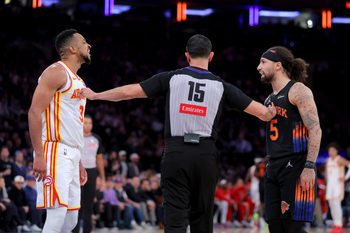 Apr 20, 2026; New York, New York, USA; Atlanta Hawks guard CJ McCollum (3) and New York Knicks guard Jose Alvarado (5) exchange words while separated by referee Zach Zarba (15) during the third quarter of game two of the first round of the 2026 NBA Playoffs at Madison Square Garden. Mandatory Credit: Brad Penner-Imagn Images