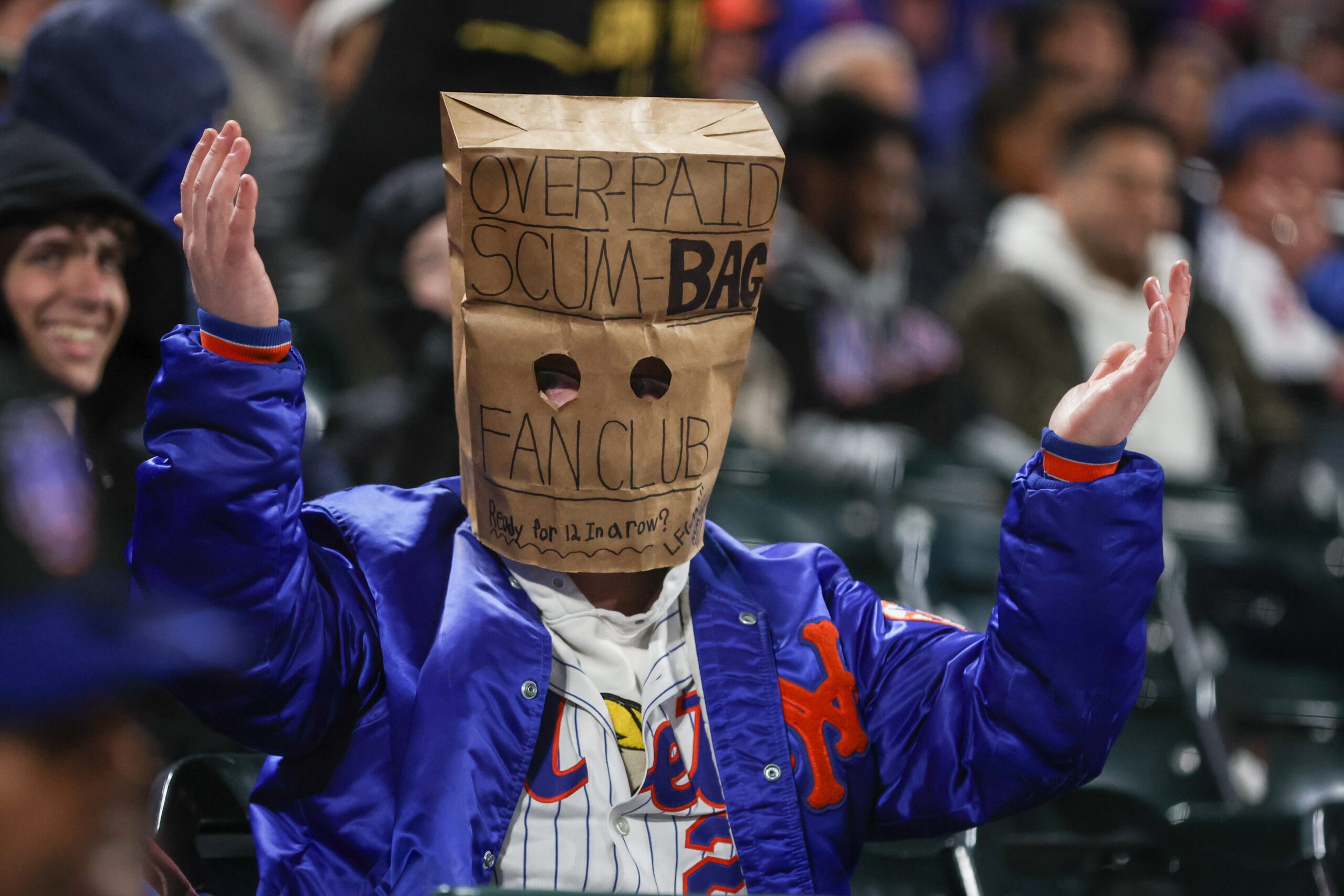Apr 21, 2026; New York City, New York, USA; A fan wears a bag in the eighth inning during a game between the Minnesota Twins and the New York Mets at Citi Field. Mandatory Credit: Wendell Cruz-Imagn Images