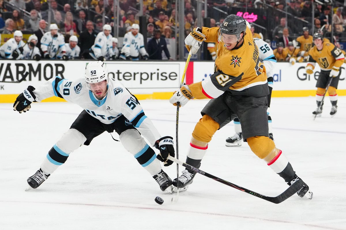 Apr 21, 2026; Las Vegas, Nevada, USA; Utah Mammoth defenseman Sean Durzi (50) attempts to deflect a shot attempt by Vegas Golden Knights center Brett Howden (21) during the first period of game two of the first round of the 2026 Stanley Cup Playoffs at T-Mobile Arena. Mandatory Credit: Stephen R. Sylvanie-Imagn Images