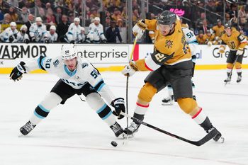 Apr 21, 2026; Las Vegas, Nevada, USA; Utah Mammoth defenseman Sean Durzi (50) attempts to deflect a shot attempt by Vegas Golden Knights center Brett Howden (21) during the first period of game two of the first round of the 2026 Stanley Cup Playoffs at T-Mobile Arena. Mandatory Credit: Stephen R. Sylvanie-Imagn Images