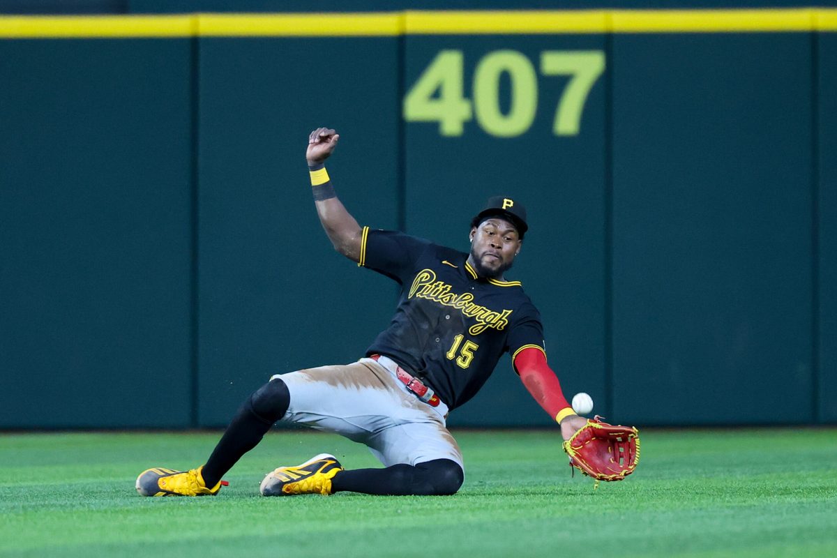 Apr 22, 2026; Arlington, Texas, USA;  Pittsburgh Pirates center fielder Oneil Cruz (15) dives but cannot make a catch during the seventh inning against the Texas Rangers at Globe Life Field. Mandatory Credit: Kevin Jairaj-Imagn Images