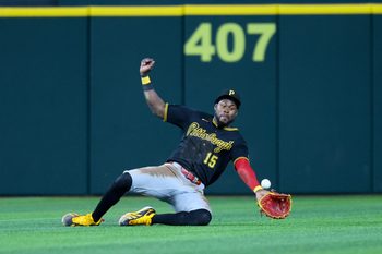 Apr 22, 2026; Arlington, Texas, USA;  Pittsburgh Pirates center fielder Oneil Cruz (15) dives but cannot make a catch during the seventh inning against the Texas Rangers at Globe Life Field. Mandatory Credit: Kevin Jairaj-Imagn Images