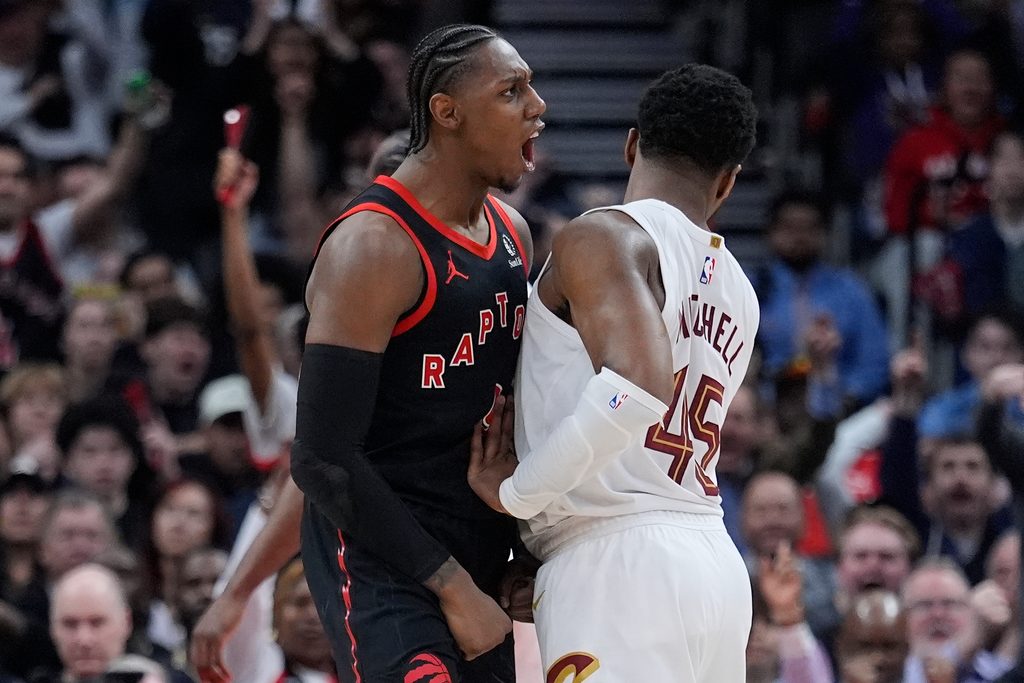 Apr 23, 2026; Toronto, Ontario, CAN; Toronto Raptors forward RJ Barrett (9) celebrates as Cleveland Cavaliers guard Donovan Mitchell (45) tries to walk away during the second half of game three of the first round of the 2026 NBA Playoffs at Scotiabank Arena. Mandatory Credit: John E. Sokolowski-Imagn Images