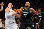 Apr 23, 2026; Minneapolis, Minnesota, USA; Denver Nuggets center Nikola Jokic (15) goes to the basket against Minnesota Timberwolves center Rudy Gobert (27) in the third quarter at Target Center. Mandatory Credit: Bruce Kluckhohn-Imagn Images
