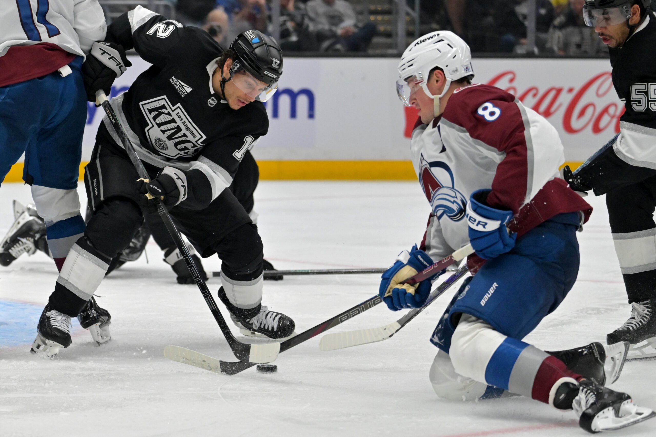 Apr 23, 2026; Los Angeles, California, USA; Los Angeles Kings left wing Trevor Moore (12) defends Colorado Avalanche defenseman Cale Makar (8) in game three of the first round of the 2026 Stanley Cup Playoffs at Crypto.com Arena. Mandatory Credit: Jayne Kamin-Oncea-Imagn Images