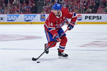 Apr 24, 2026; Montreal, Quebec, CAN; Montreal Canadiens forward Nick Suzuki (14) plays the puck against the Tampa Bay Lightning during the third period in game three of the first round of the 2026 Stanley Cup Playoffs at the Bell Centre. Mandatory Credit: Eric Bolte-Imagn Images