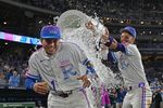 Apr 24, 2026; Kansas City, Missouri, USA;  Kansas City Royals shortstop Bobby Witt Jr. (7) douses left fielder Isaac Collins (1) with ice water after beating the Los Angeles Angels at Kauffman Stadium. Mandatory Credit: Peter Aiken-Imagn Images