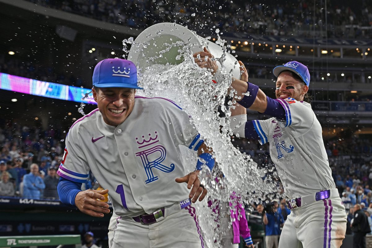 Apr 24, 2026; Kansas City, Missouri, USA; Kansas City Royals shortstop Bobby Witt Jr. (7) douses left fielder Isaac Collins (1) with ice water after beating the Los Angeles Angels at Kauffman Stadium. Mandatory Credit: Peter Aiken-Imagn Images