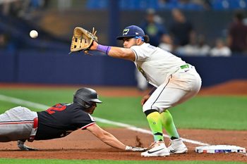 Apr 24, 2026; St. Petersburg, Florida, USA; Minnesota Twins infielder Brooks Lee (22) slides to first base during the seventh inning against Tampa Bay Rays infielder Jonathan Aranda (8) at Tropicana Field. Mandatory Credit: Pablo Robles-Imagn Images
