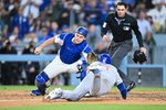 Apr 24, 2026; Los Angeles, California, USA; Los Angeles Dodgers catcher Will Smith (16) tags out Chicago Cubs left fielder Ian Happ (8) at home plate during the eighth inning at Dodger Stadium. Mandatory Credit: William Liang-Imagn Images