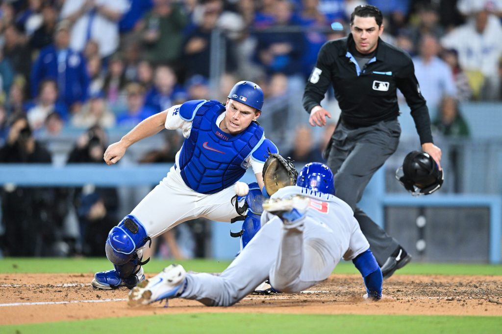Apr 24, 2026; Los Angeles, California, USA; Los Angeles Dodgers catcher Will Smith (16) tags out Chicago Cubs left fielder Ian Happ (8) at home plate during the eighth inning at Dodger Stadium. Mandatory Credit: William Liang-Imagn Images