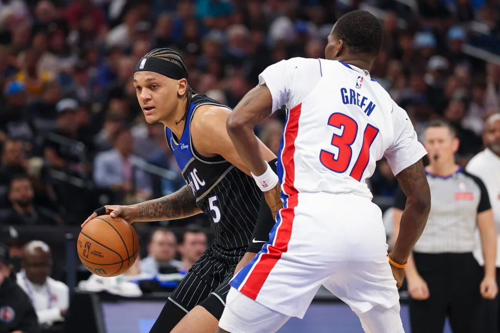Apr 25, 2026; Orlando, Florida, USA; Orlando Magic forward Paolo Banchero (5) is guarded by Detroit Pistons guard Javonte Green (31) in the third quarter during game three of the first round of the 2026 NBA Playoffs at Kia Center. Mandatory Credit: Nathan Ray Seebeck-Imagn Images