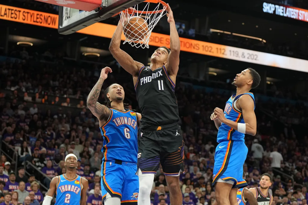 Apr 25, 2026; Phoenix, Arizona, USA; Phoenix Suns forward Oso Ighodaro (11) dunks over Oklahoma City Thunder forward Jaylin Williams (6) in the second half during game three of the first round of the 2026 NBA Playoffs at Mortgage Matchup Center. Mandatory Credit: Rick Scuteri-Imagn Images