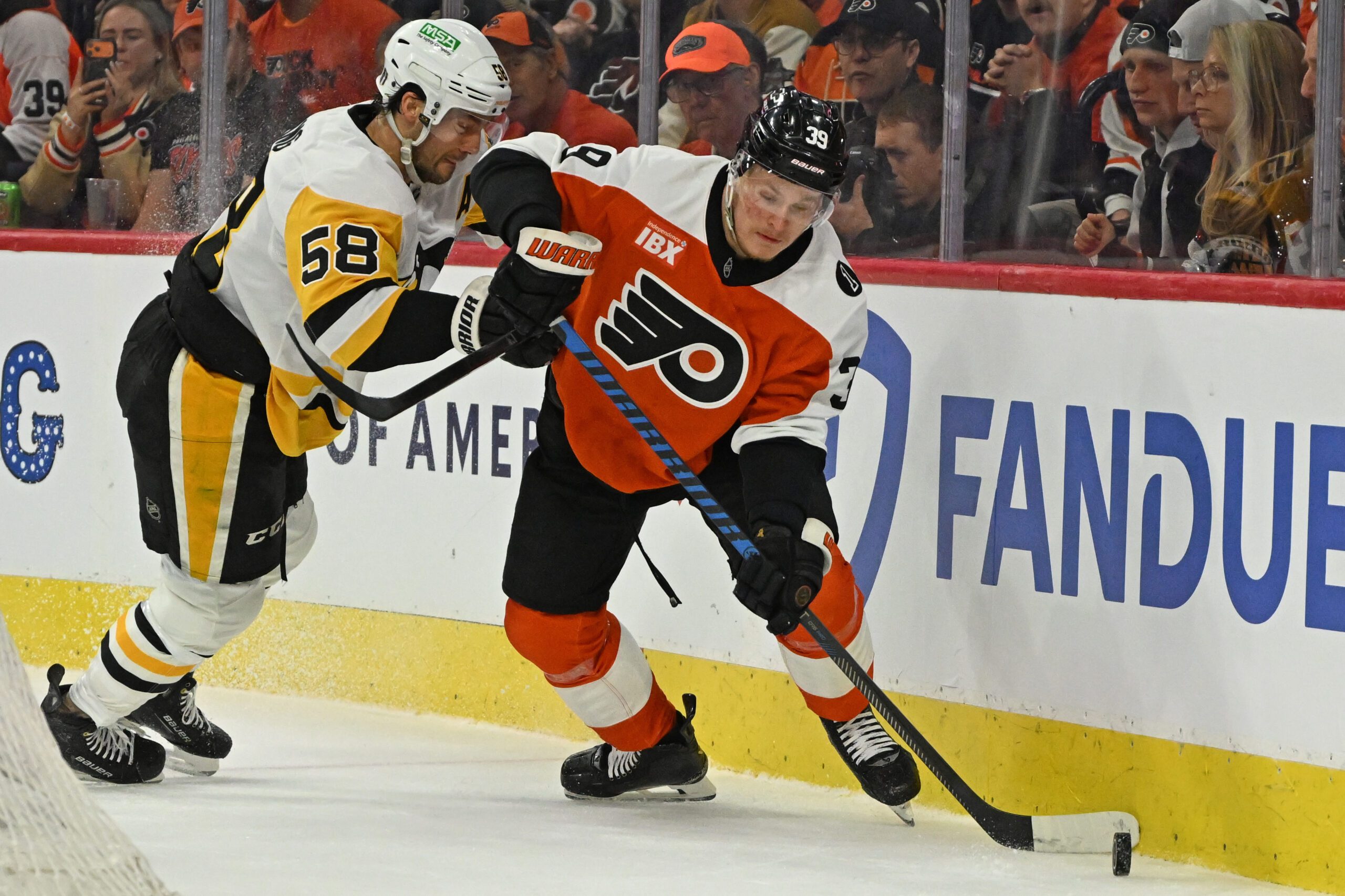 Apr 25, 2026; Philadelphia, Pennsylvania, USA; Philadelphia Flyers right wing Matvei Michkov (39) skates with the puck against Pittsburgh Penguins defenseman Kris Letang (58) during the first period in game four of the first round of the 2026 Stanley Cup Playoffs at Xfinity Mobile Arena. Mandatory Credit: Eric Hartline-Imagn Images