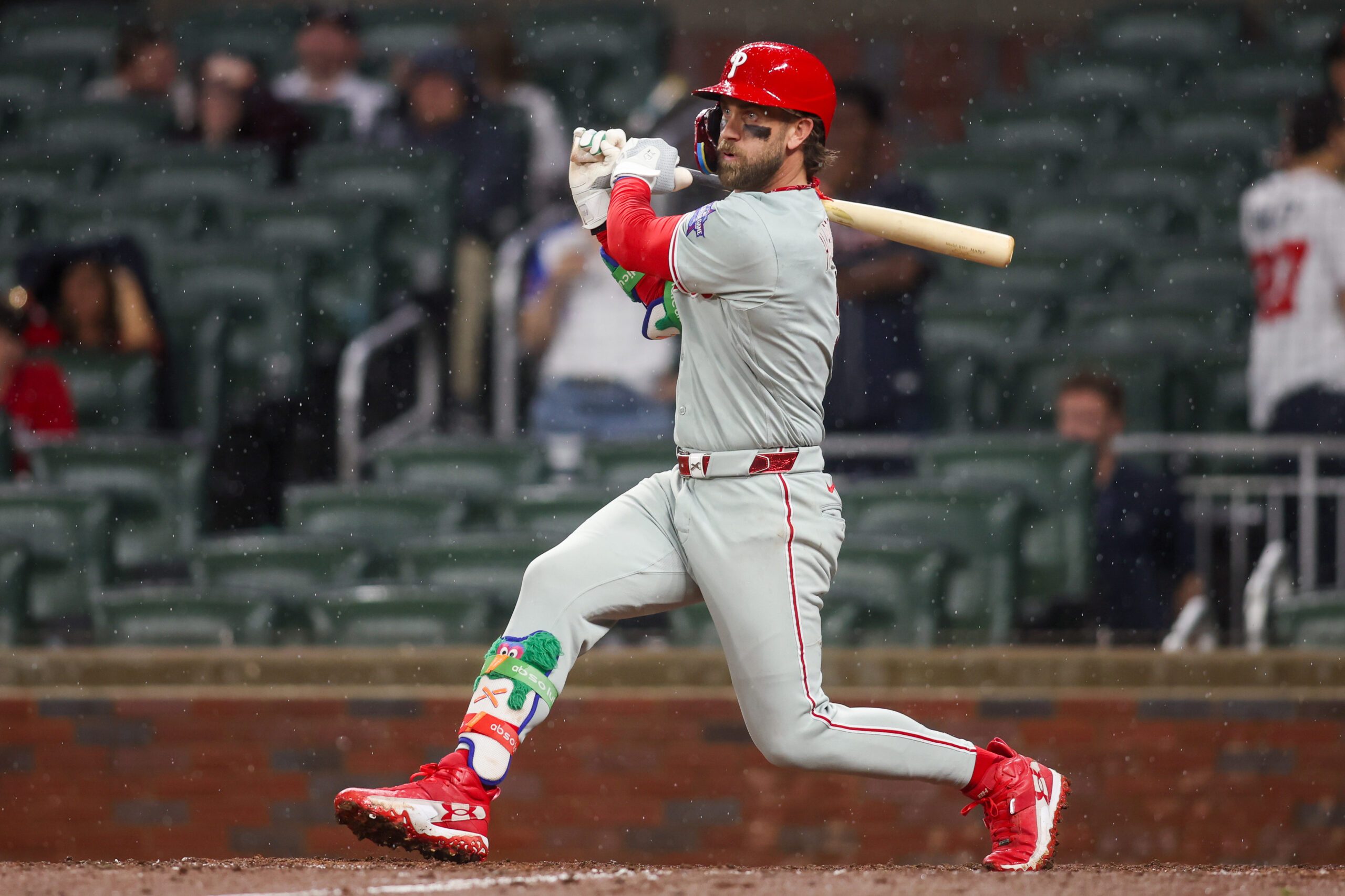 Apr 25, 2026; Atlanta, Georgia, USA; Philadelphia Phillies first baseman Bryce Harper (3) hits a two-run single against the Atlanta Braves in the tenth inning at Truist Park. Mandatory Credit: Brett Davis-Imagn Images