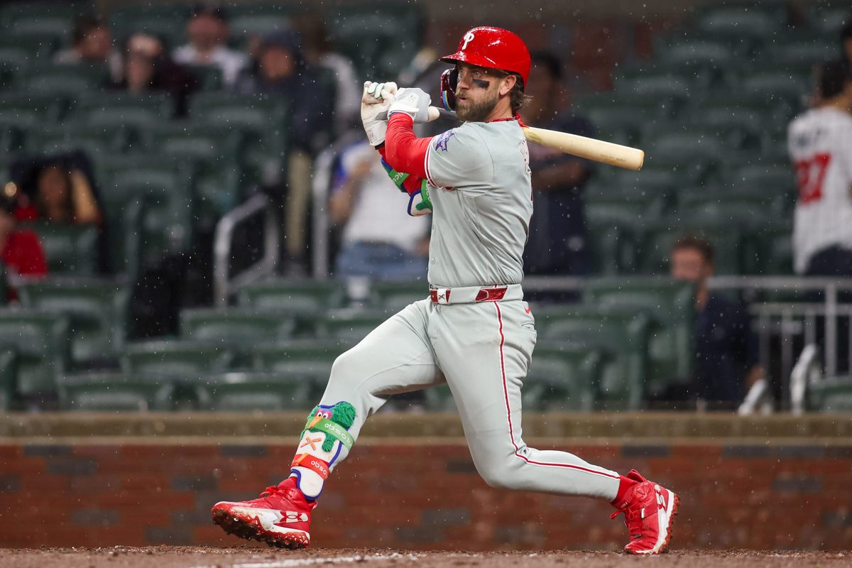 Apr 25, 2026; Atlanta, Georgia, USA; Philadelphia Phillies first baseman Bryce Harper (3) hits a two-run single against the Atlanta Braves in the tenth inning at Truist Park. Mandatory Credit: Brett Davis-Imagn Images
