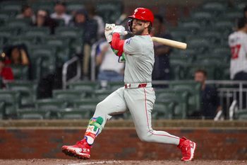 Apr 25, 2026; Atlanta, Georgia, USA; Philadelphia Phillies first baseman Bryce Harper (3) hits a two-run single against the Atlanta Braves in the tenth inning at Truist Park. Mandatory Credit: Brett Davis-Imagn Images