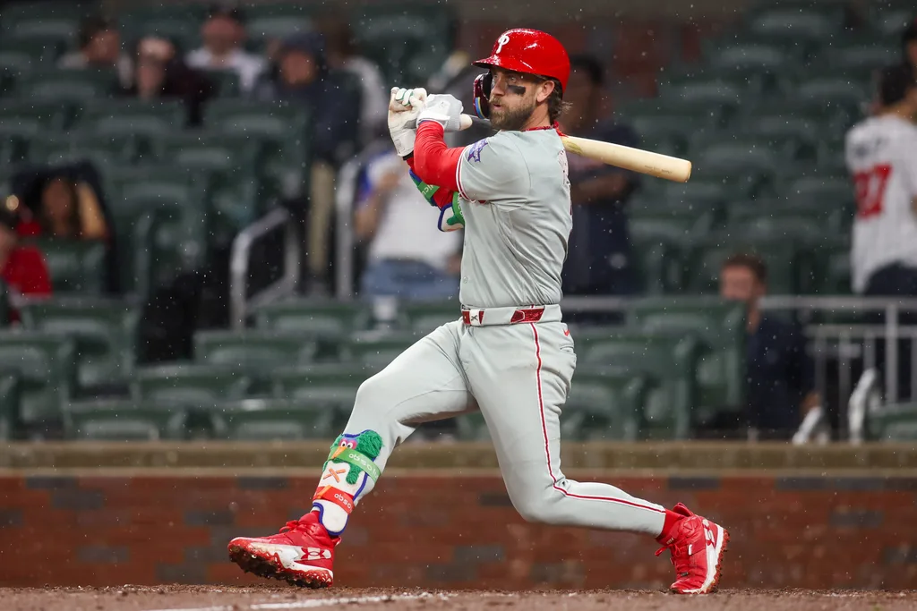 Apr 25, 2026; Atlanta, Georgia, USA; Philadelphia Phillies first baseman Bryce Harper (3) hits a two-run single against the Atlanta Braves in the tenth inning at Truist Park. Mandatory Credit: Brett Davis-Imagn Images