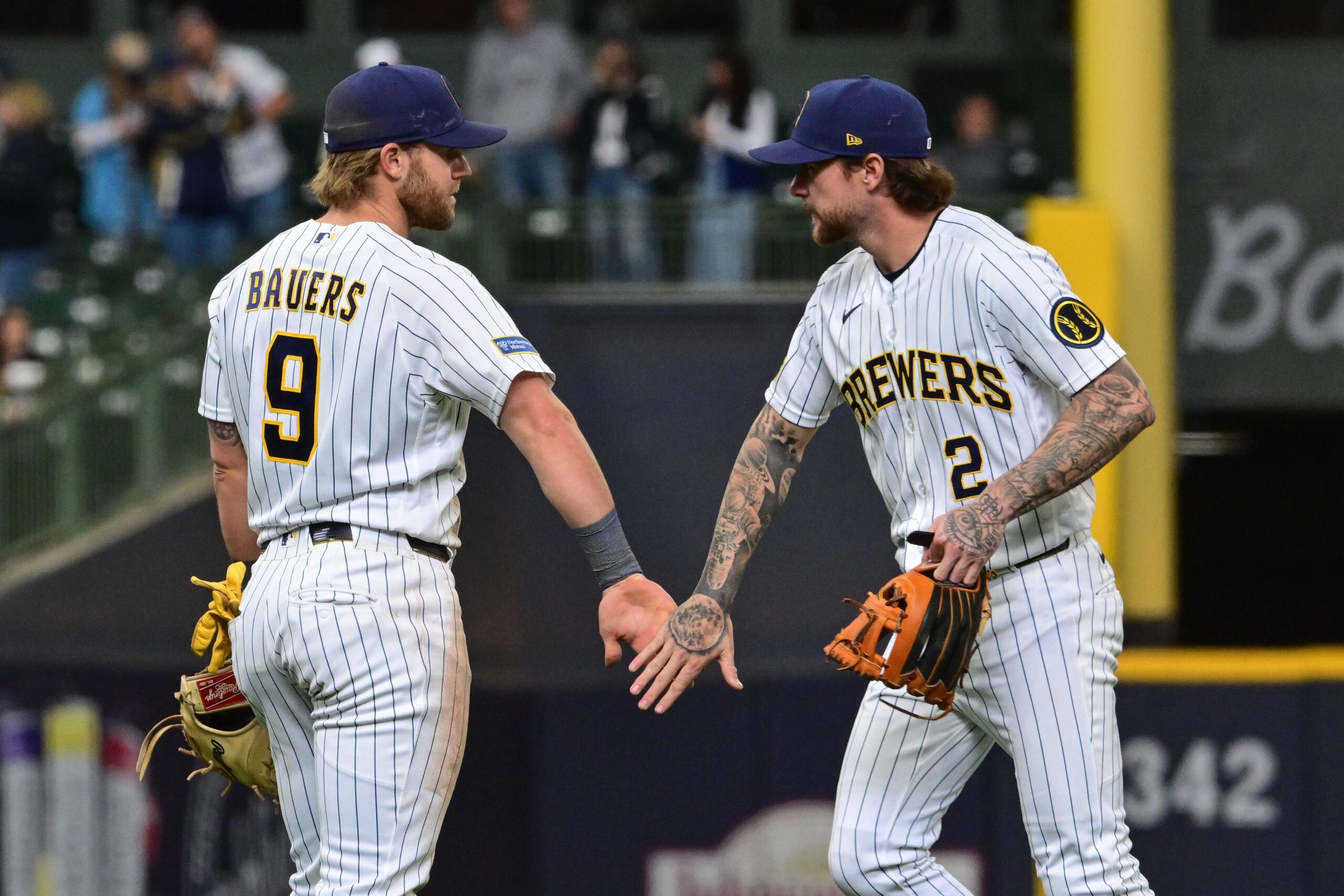 Apr 26, 2026; Milwaukee, Wisconsin, USA; Milwaukee Brewers first baseman Jake Bauers (9) and second baseman Brice Turang (2) celebrates after beating the Pittsburgh Pirates at American Family Field. Mandatory Credit: Benny Sieu-Imagn Images