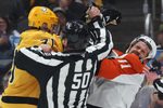 Apr 27, 2026; Pittsburgh, Pennsylvania, USA;  Pittsburgh Penguins center Evgeni Malkin (71) checks Philadelphia Flyers right wing Travis Konecny (11) after the play as linesman Scott Cherrey (50) intervenes during the first period in game five of the first round of the 2026 Stanley Cup Playoffs at PPG Paints Arena. Mandatory Credit: Charles LeClaire-Imagn Images