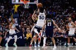 Apr 27, 2026; Denver, Colorado, USA; Minnesota Timberwolves forward Julius Randle (30) attempts a shot against Denver Nuggets forward Spencer Jones (21) as guard Jamal Murray (27) defends in the fourth quarter during game five of the first round of the 2026 NBA Playoffs at Ball Arena. Mandatory Credit: Isaiah J. Downing-Imagn Images