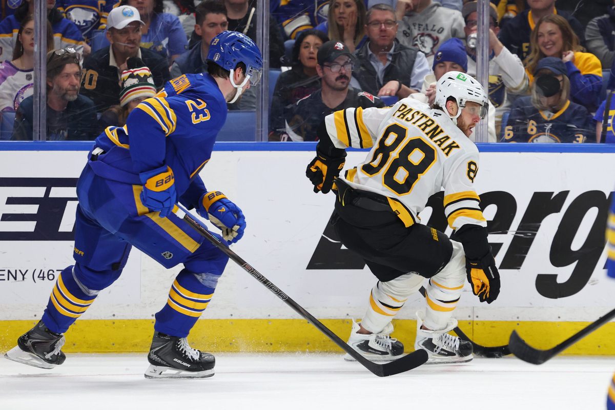 Apr 28, 2026; Buffalo, New York, USA; Boston Bruins right wing David Pastrnak (88) controls the puck as Buffalo Sabres defenseman Mattias Samuelsson (23) defends during the third period in game five of the first round of the 2026 Stanley Cup Playoffs at KeyBank Center. Mandatory Credit: Timothy T. Ludwig-Imagn Images