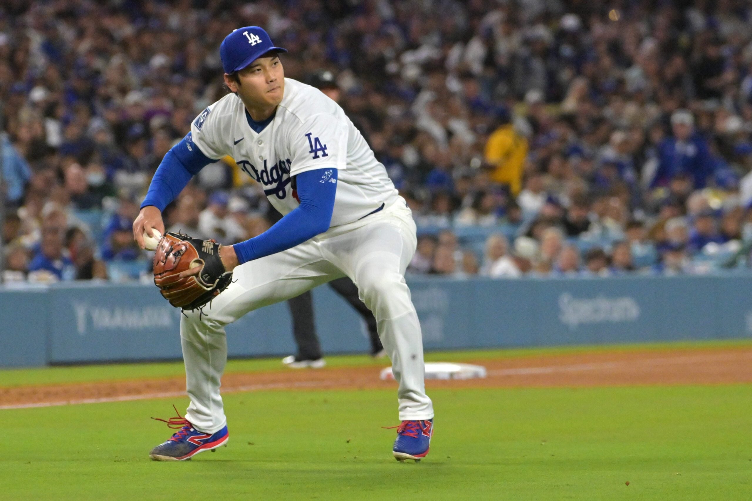 Apr 28, 2026; Los Angeles, California, USA; Los Angeles Dodgers starting pitcher Shohei Ohtani (17) makes a play to throw Miami Marlins center fielder Jakob Marsee (87) out at first base in the fifth inning at Dodger Stadium. Mandatory Credit: Jayne Kamin-Oncea-Imagn Images
