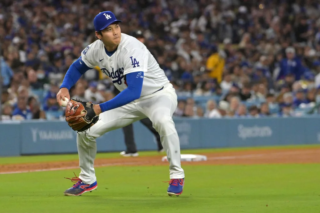 Apr 28, 2026; Los Angeles, California, USA; Los Angeles Dodgers starting pitcher Shohei Ohtani (17) makes a play to throw Miami Marlins center fielder Jakob Marsee (87) out at first base in the fifth inning at Dodger Stadium. Mandatory Credit: Jayne Kamin-Oncea-Imagn Images
