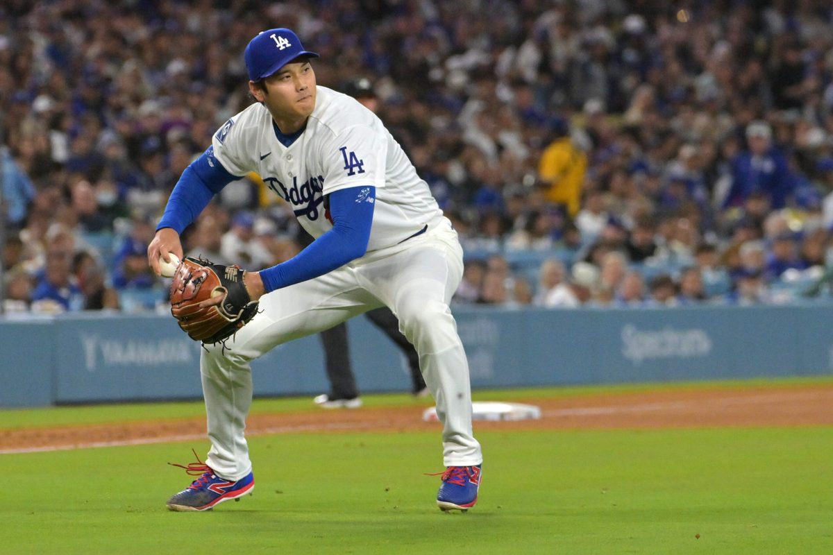 Apr 28, 2026; Los Angeles, California, USA; Los Angeles Dodgers starting pitcher Shohei Ohtani (17) makes a play to throw Miami Marlins center fielder Jakob Marsee (87) out at first base in the fifth inning at Dodger Stadium. Mandatory Credit: Jayne Kamin-Oncea-Imagn Images